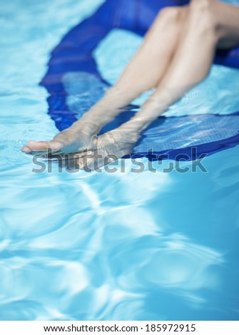 Woman on Pool Raft, Focus on Legs