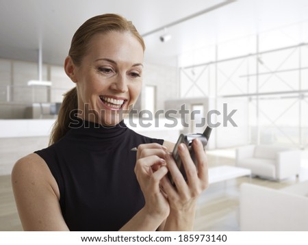 Happy Woman Using Electronic Organizer