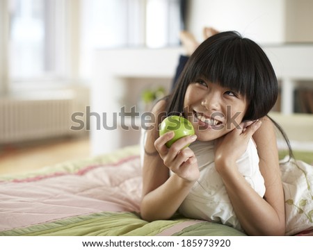 Mid Adult Woman Having Apple and Thinking
