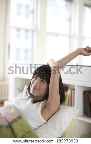 Happy Mid Adult Woman Waking Up in Bed