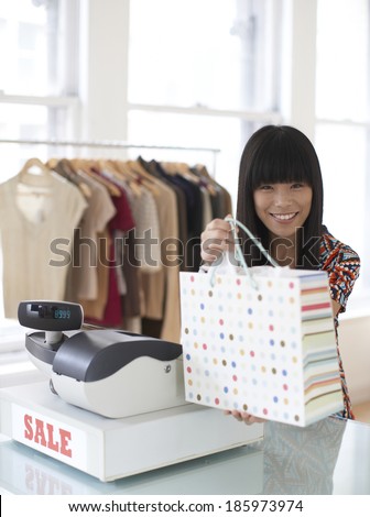 Sales Clerk Giving Shopping Bag