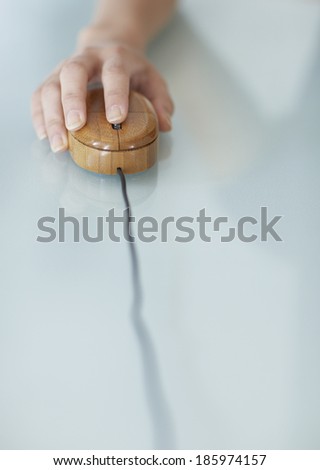 Close-Up of Woman Using Wooden Computer Mouse