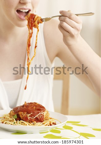 Midsection of Young Woman Eating Spaghetti