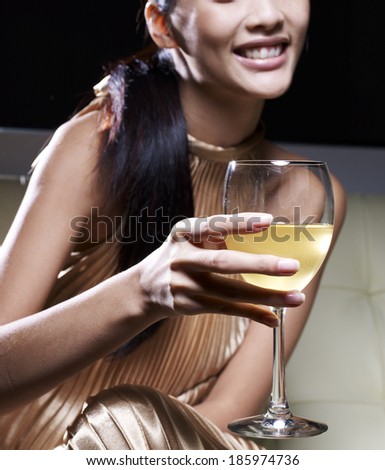 Close-Up of Woman in Evening Dress Drinking White Wine