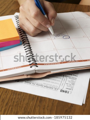 Person Noting Down Tax Return Date