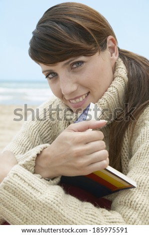Mid-Adult Woman with Book on Beach