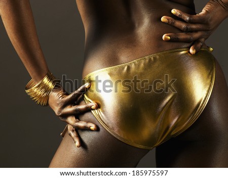 Rear View of Young Woman in Golden Bikini Bottom