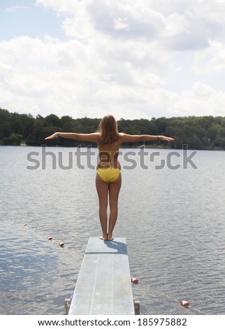 Teenage Girl Standing on Diving Board