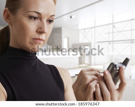 Mid-Adult Woman Using Electronic Organizer