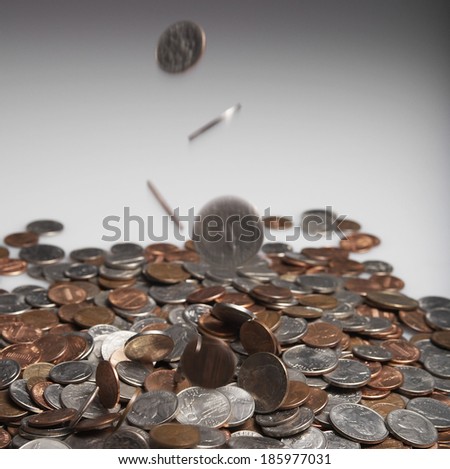 Coins Falling on Pile