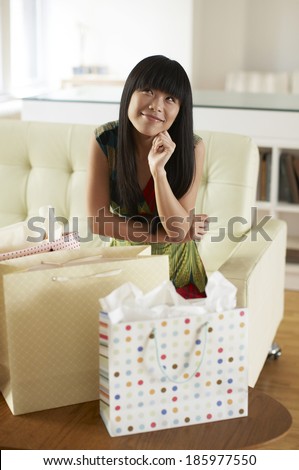 Mid Adult Woman with Shopping Bags Day Dreaming