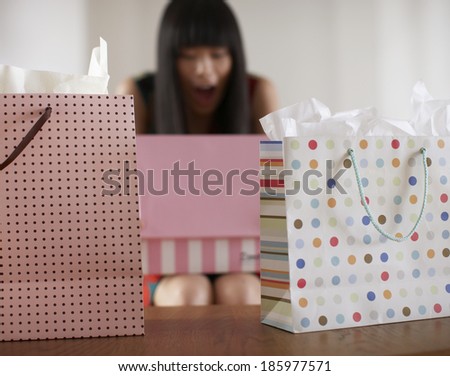 Low Angle View of Mid Adult Woman Opening Gift Bags