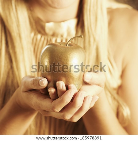 Golden Apple in Woman\'s Hands