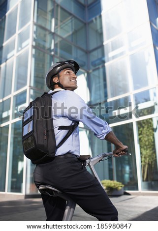 Businessman with Solar Panelled Backpack on Folding Bike