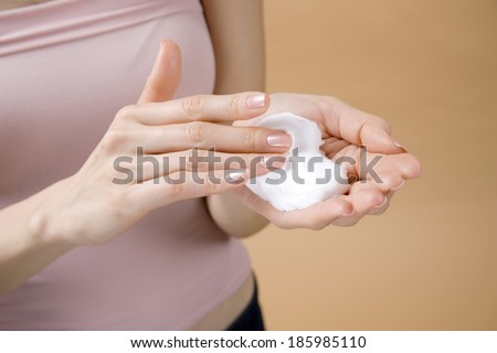 hands of woman touching lather or foam