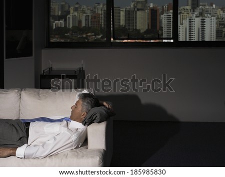 Mature Businessman Sleeping on Couch in Office