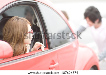 woman looking back from car window