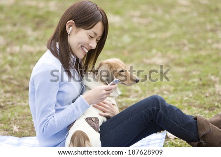 woman and dog listening to portable music
