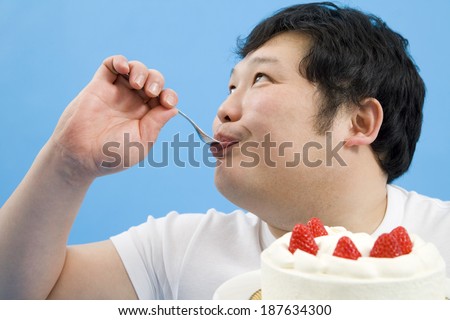 obese man eating cake