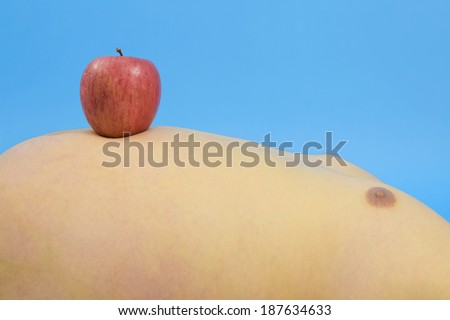 stomach of person with metabolic syndrome, an apple is on it