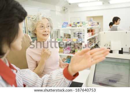 senior woman asking for direction at convenience store
