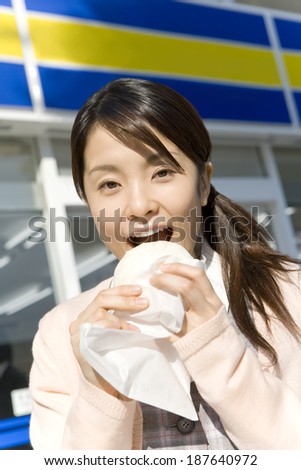 woman eating meat-filled steamed bun