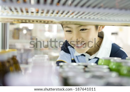 boy choosing drink at convenience store