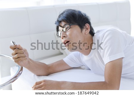 man looks at watch when he just woke up