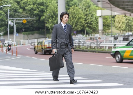 businessman crossing at the cross walk