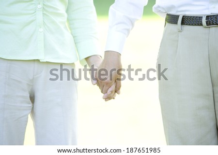 senior husband and wife holding hands