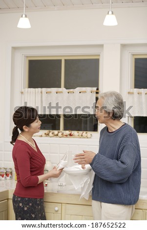 husband and wife talking in kitchen