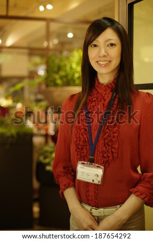 woman wearing ID badge on lanyard around her neck