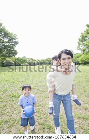 smiling family playing in park