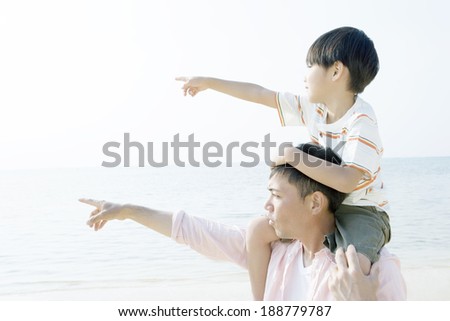 father and son pointing to the distance