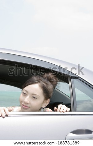 woman leaning out from backseat of car
