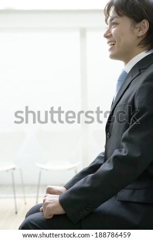 man in suit sitting on chair