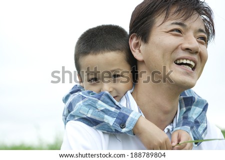 Father giving son a piggy-back ride