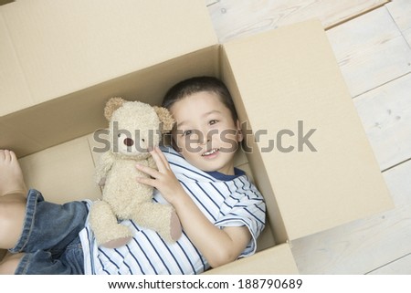 boy goes in cardboard box and plays