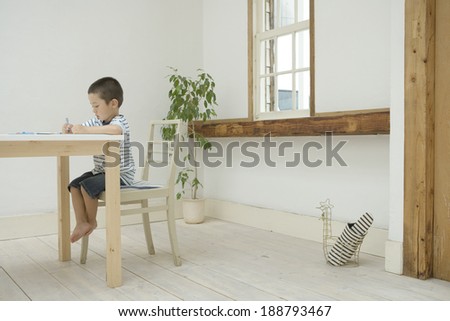 boy drawing a picture on table