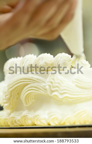 Patissier making cakes in patisserie