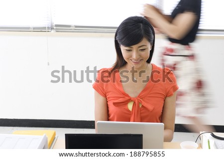 Japanese woman in her twenties facing PC