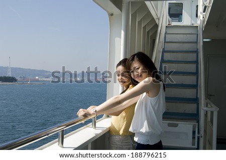 Two Japanese women in their twenties looking sea from ferry
