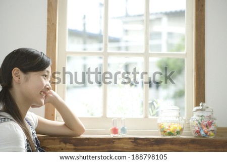 smiling girl by window