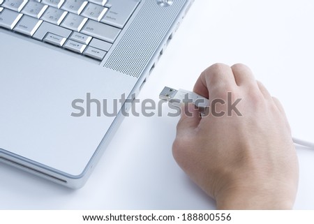 Hand inserting USB