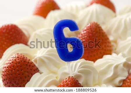 Strawberry fancy cake with candle of No. 6