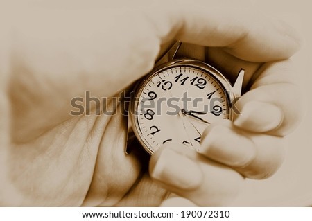 Someone holding a watch without bracelet in one hand.