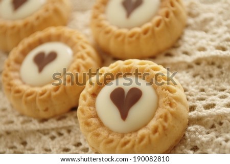 Round cookies with a white center containing a heart.