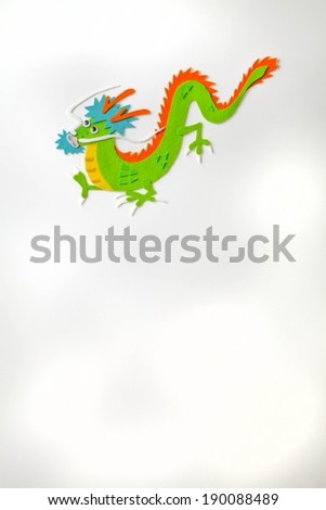 A colorful green dragon stretches across a white background.