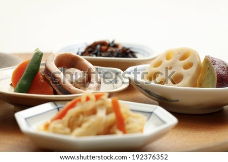 A variety of food dishes served in octagonal white dishes with a blue pattern