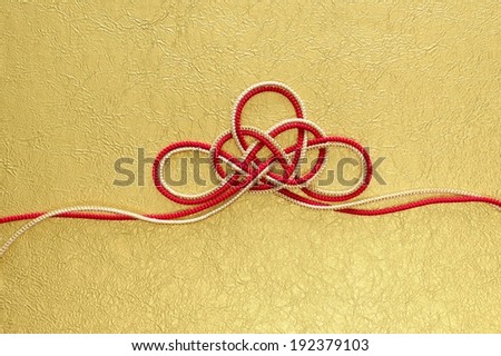 A white and red piece of string tied up.